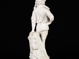 white marble statue of a man with a bag of luggage
