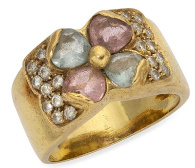 a close up of a gold ring with a flower design