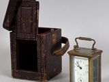 a small wooden box with a clock inside of it