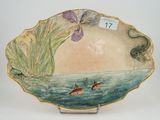 a plate with a painting of a fish and flowers on it