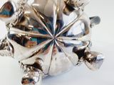a silver turtle with a starburst on its back