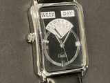 a black watch with a silver face on a black leather strap