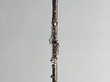 a close up of a clarinet on a gray background