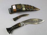 two knives and a knife holder on a table