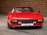 a red sports car that is parked in a garage
