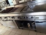 a large stainless steel stove in a kitchen with a lot of counter space