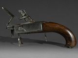 an old gun with a wooden handle on a gray background