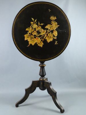 an image of a black and gold table with flowers on it