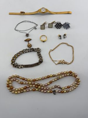 a group of assorted jewelry including a necklace, bracelet, and broocher