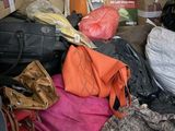 a pile of luggage sitting in the back of a truck