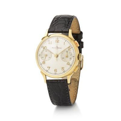 a close up of a watch on a white background with a black strap