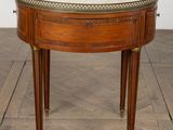 an image of a small table with a marble top on a wooden floor