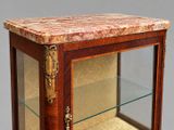 a glass display case with a marble top on it