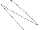 a pair of silver plated necklaces on a white background