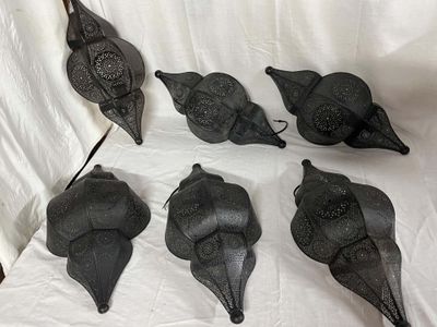 six black birds are sitting on a white sheet on a white surface