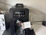 a black coffee machine sitting on a counter next to a toaster and toaster
