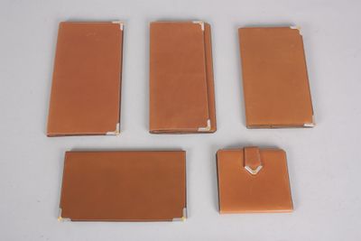 four pieces of brown leather are arranged on a white surface