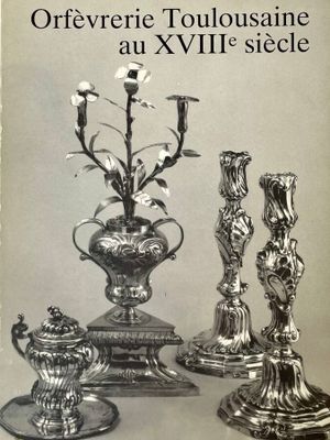 a book with a picture of a silver vase and candlesticks