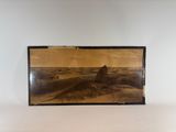a black and white photo of a desert landscape in a frame