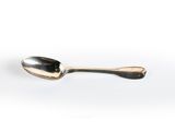 a spoon that is sitting on a white surface