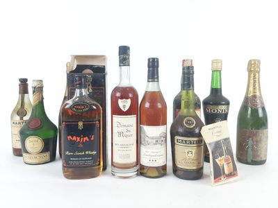 several bottles of alcohol are lined up in a row on a white surface