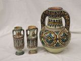 three vases that are sitting next to each other on a table
