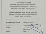 a close up of a certificate with a picture of a person holding a camera