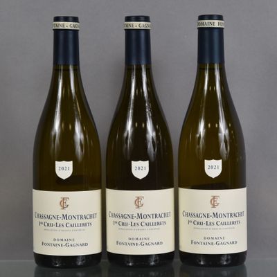 three bottles of wine are lined up on a table