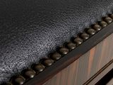 close up of a black leather stool with studding on the back