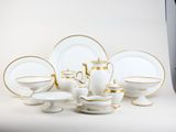 a lot of white and gold plates and cups