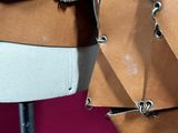 several pieces of brown leather on a mannequin