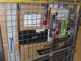 a large metal cage with a bunch of books in it