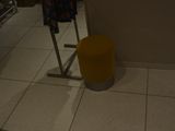 a yellow stool in the middle of a room
