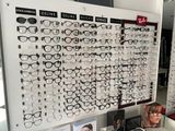 a display of glasses on the wall in a store