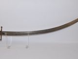 une vieille épée avec un manche en bois sur une surface blanche