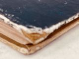 an old book that is sitting on top of a table