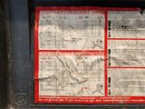 a red and white poster on the back of a bus