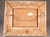 an old wooden picture frame with a label on it