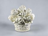 a white vase with a bunch of flowers in it