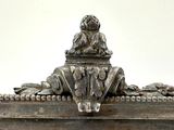 a silver box with a statue on top of it