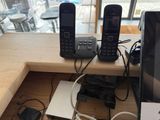 two cell phones and a laptop on a desk