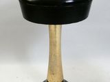 an image of a black and gold stool on a white background