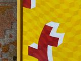 a picture of a picture of a yellow and red painting on the wall