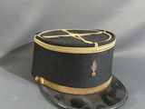 a black hat with a gold band on it
