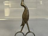 a pair of scissors sitting on top of a clear box