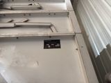 a metal shelf that has a bunch of tools on it