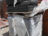 a pile of metal items sitting on top of a pile of bricks