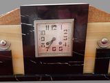 marble mantle clock with black and white marbles on a gray background