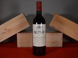 a bottle of wine sitting on a table next to two wooden boxes
