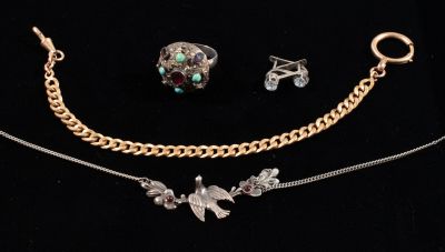 three pieces of jewelry are displayed on a black surface